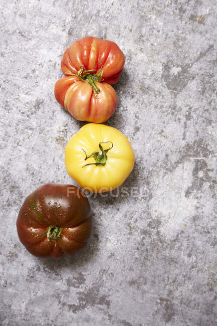 Fresh tomatoes on a gray background. top view. — Stock Photo