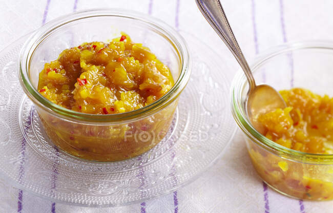 Tangy peach chutney in glass bowls — Stock Photo