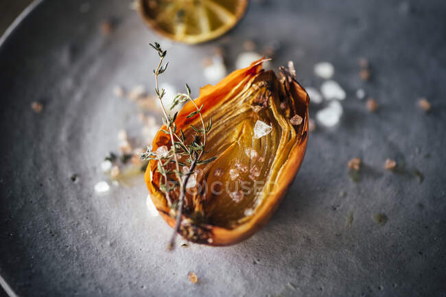 Baked fish with spices and herbs on a black background. — Stock Photo