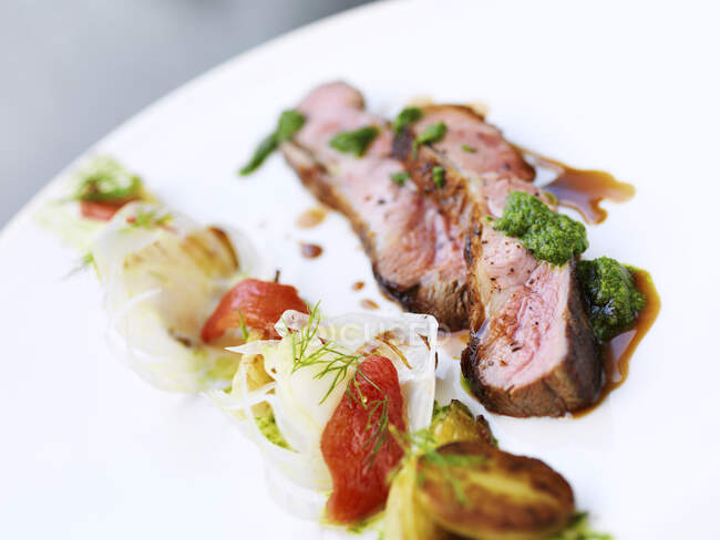 Lamb with pesto and summer vegetables — Stock Photo