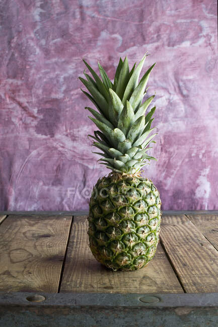Pineapple on a wooden table — Stock Photo