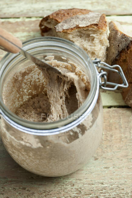 Natural yeast in mason jar with knife — Stock Photo