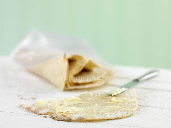 Homemade bread with butter and cream on a white plate — Stock Photo