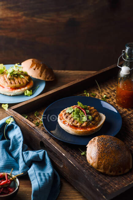 Curry chicken burger with sweet chilli sauce and fresh coriander — Stock Photo