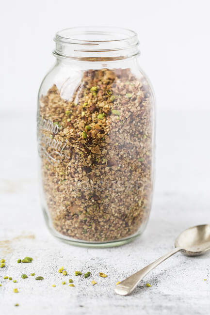 A jar of breakfast granola with pistachios — Stock Photo