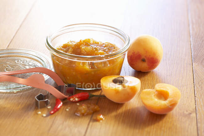 Apricots and ginger chutney with fresh chili in a mason jar — Stock Photo