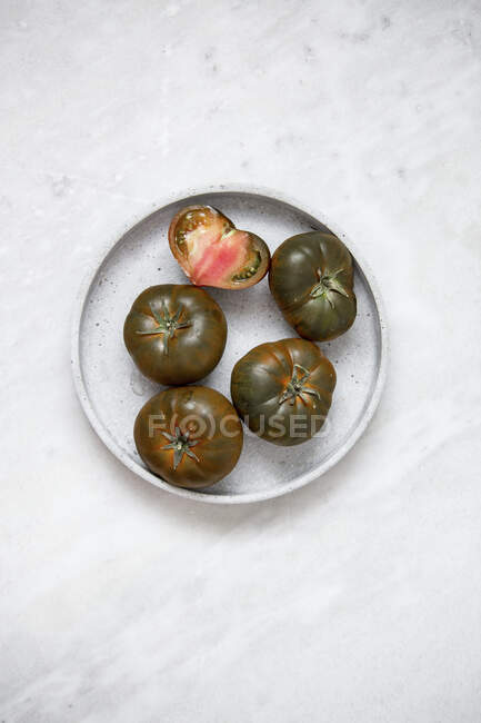 Organic Tomato 'Marmande black' on marble backgroun — Foto stock