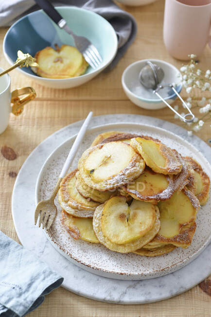 Pancakes with apple slices — Stock Photo