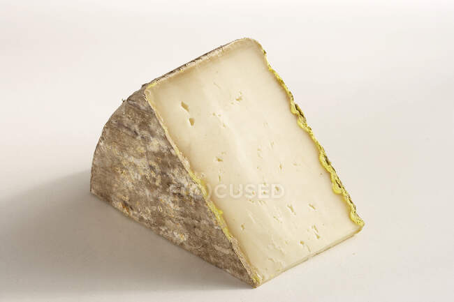 Piece of French hard sheep's cheese — Stock Photo