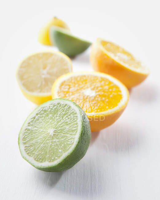 Lime, orange and lemon halves — Stock Photo