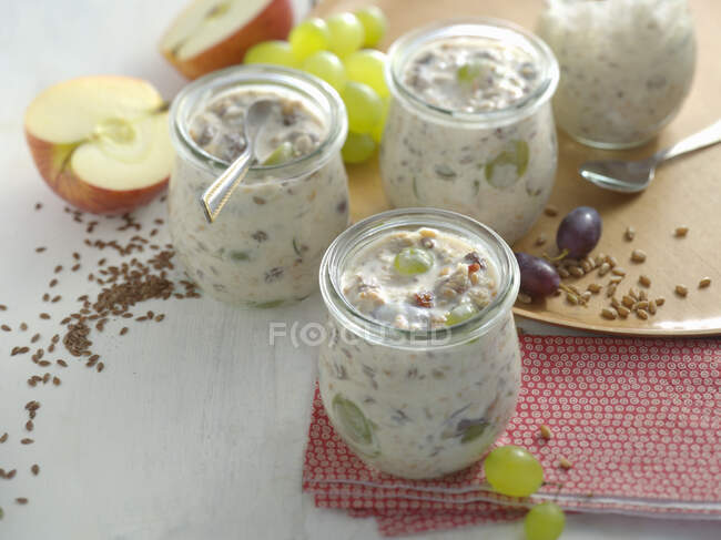 Autumnal fresh grain muesli with apples and grapes in jars — Stock Photo