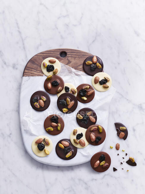 Chocolate thaler with nuts and seeds — Stock Photo