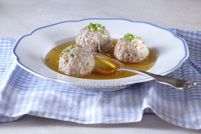 Liver dumpling soup with spoon — Stock Photo