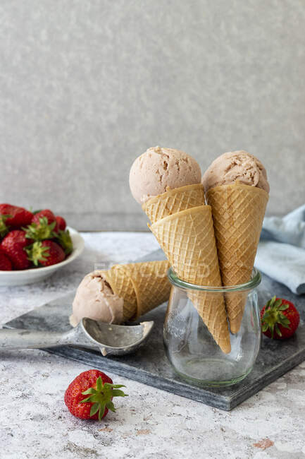 Fresa crema agradable en cono de helado - foto de stock