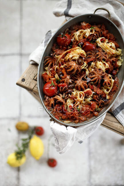 Tagliatelle with seafood and tomatoes in metal tin — Stock Photo