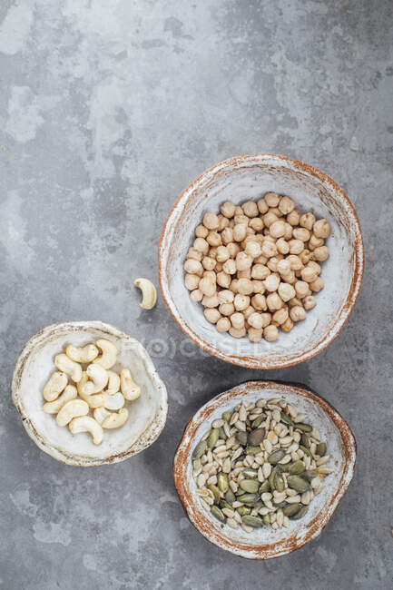 Seed mix, chickpeas and cashews in hand made clay bowls — Stock Photo