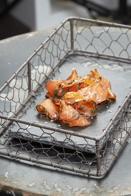 Smoked salmon in a grill basket — Stock Photo