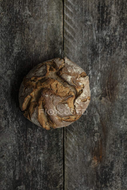 Loaf of bread on wooden background — Stock Photo