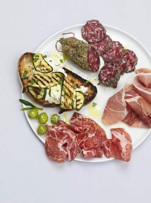 Antipasti plate with meat, prosciutto and salami — Stock Photo
