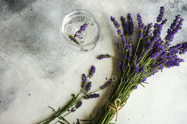 Summer detox lemonade with lavender, lemon and mint in vintage glass with straw on rustic background with copy space — Stock Photo