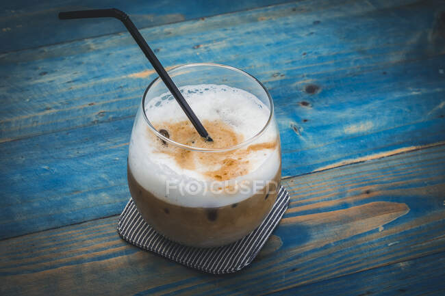 Iced latte on a blue wooden table — Stock Photo