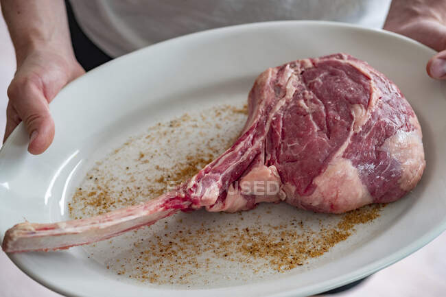 Tomahawk steak on white plate — Stock Photo