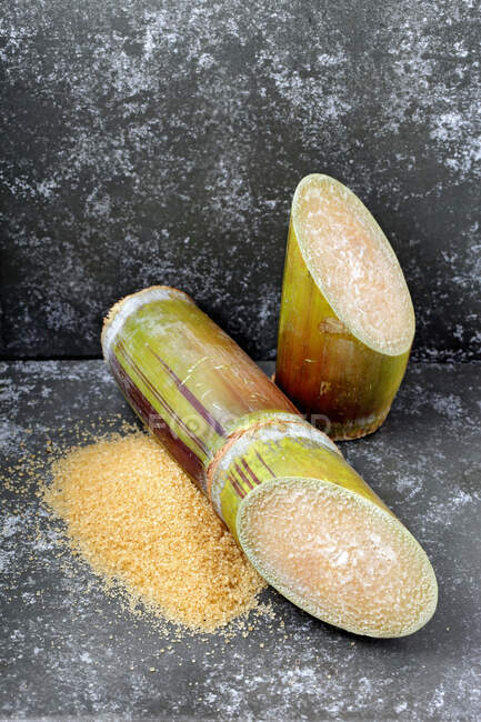 Green banana slices with salt and pepper on a stone surface — Stock Photo