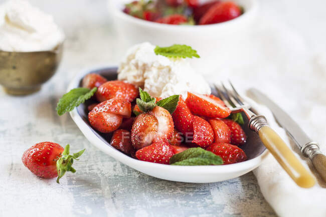 Fresh strawberries dessert with mint and cream — Stock Photo