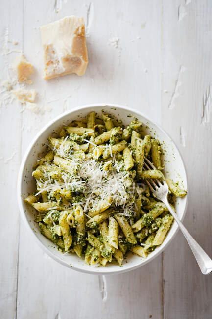 Pasta with cheese and pesto in white bowl — Stock Photo