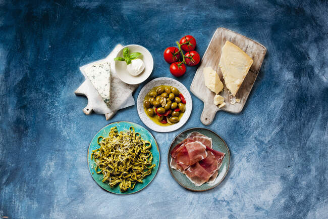 Italian food concept-healthy snacks, cheese, tomatoes, mushrooms, olive oil and olives — Stock Photo