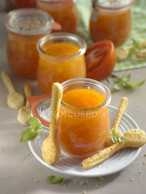 Tomato soup in glasses served with puff pastry spoons — Foto stock