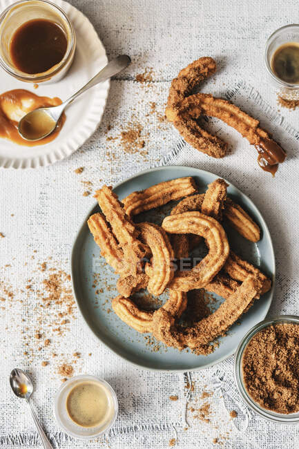 Churros with coffee on table — Stock Photo