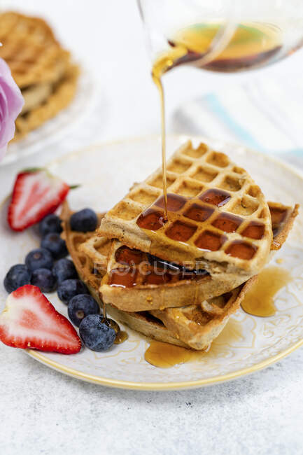 Healthy breakfast waffles with maple syrup — Stock Photo