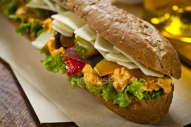 Sandwich filled with parmesan, vegetables and mustard sauce — Stock Photo