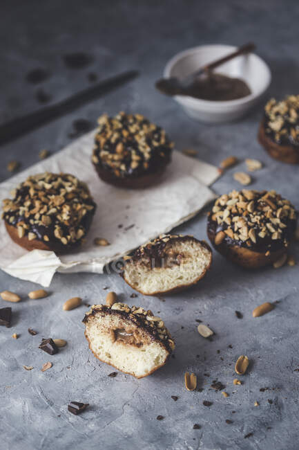 Vegan doughnuts with a caramel filling, chocolate ganache and peanuts — Stock Photo