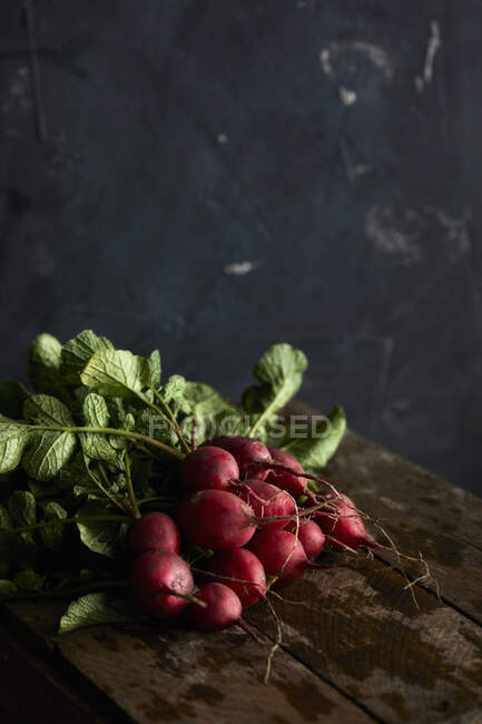 Fresh radishes on a wooden background — Stock Photo