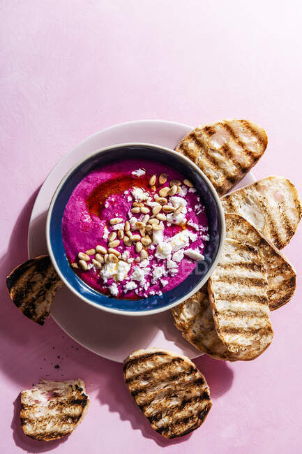 Whipped feta and beetroot dip with pine nuts and olive oil — Stock Photo