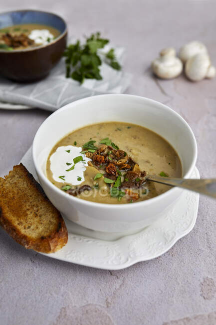 Creamy mushroom soup with baked bread and fresh parsley — Stock Photo