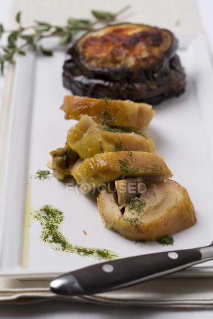Rabbit roulade with an aubergine bake and salsa verde — Stock Photo