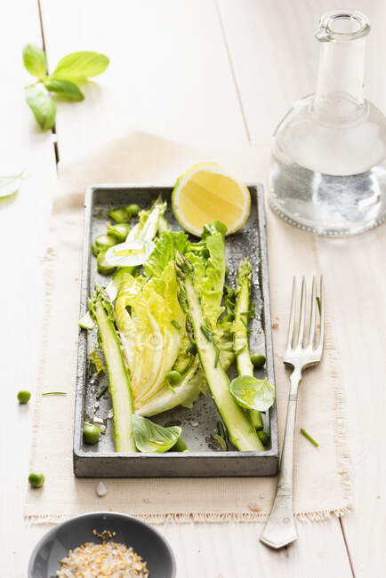Lettuce leaves with asparagus and peas — Stock Photo