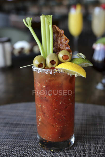Bloody mary with olives, celery and bacon — Stock Photo