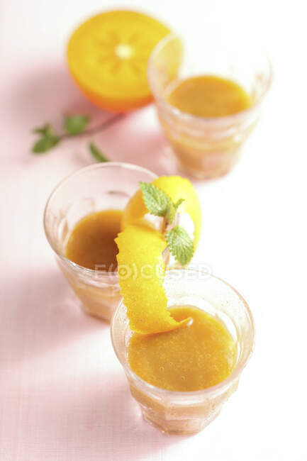Persimmon and tamarillo smoothie with orange and ice — Stock Photo