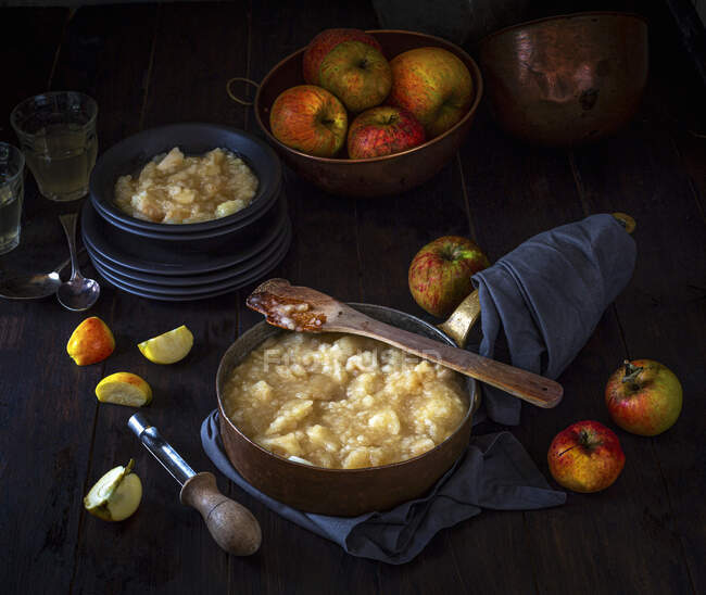 Stewed apples in a pan and bowl with orchard picked apples — Stock Photo