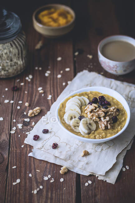 Pumpkin porridge with bananas, dried cranberries and walnuts — Stock Photo