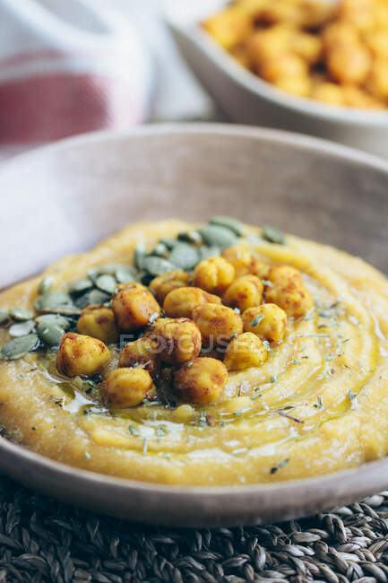Butternut squash cream with spicy chickpeas and pumpkin seeds — Stock Photo