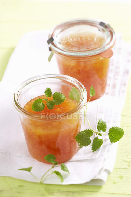 Homemade rhubarb and orange jam with lemon balm — Stock Photo