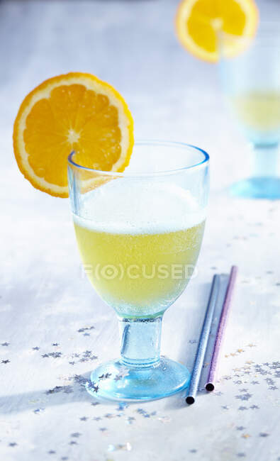Glass of drink with fresh orange slice — Stock Photo