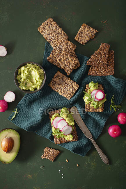 Keto crispbreads with avocado cream and radishes — Stock Photo
