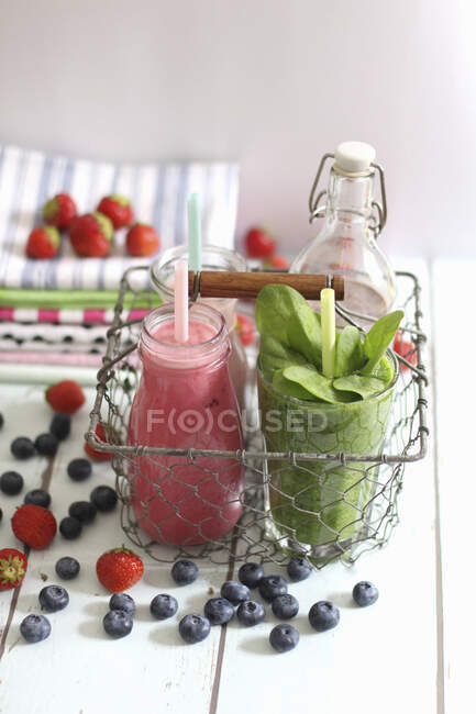 Colorful smoothies in a wire basket — Stock Photo