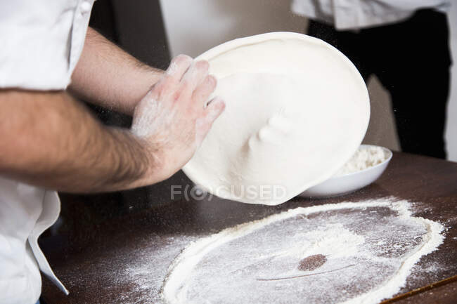 Preparing Pizza - Flatten and shape the dough — Stock Photo